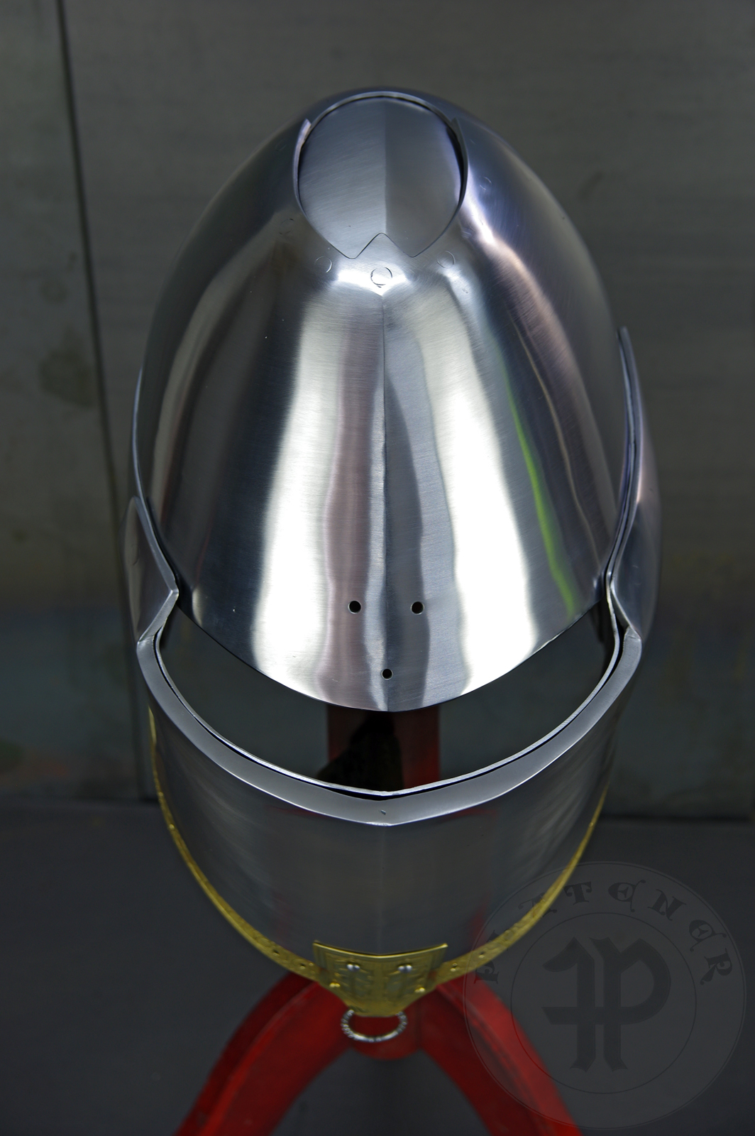 My interpretation of a tournament helm based on the Henry V helm - part of his funeral achievement from Westminster Abbey. It represents an early style of jousting helm dated for 1380-1420. It is composed of five primary plates: rear plate, brown plate, crown plate, face plate and monstrous thick reinforcing plate in front.