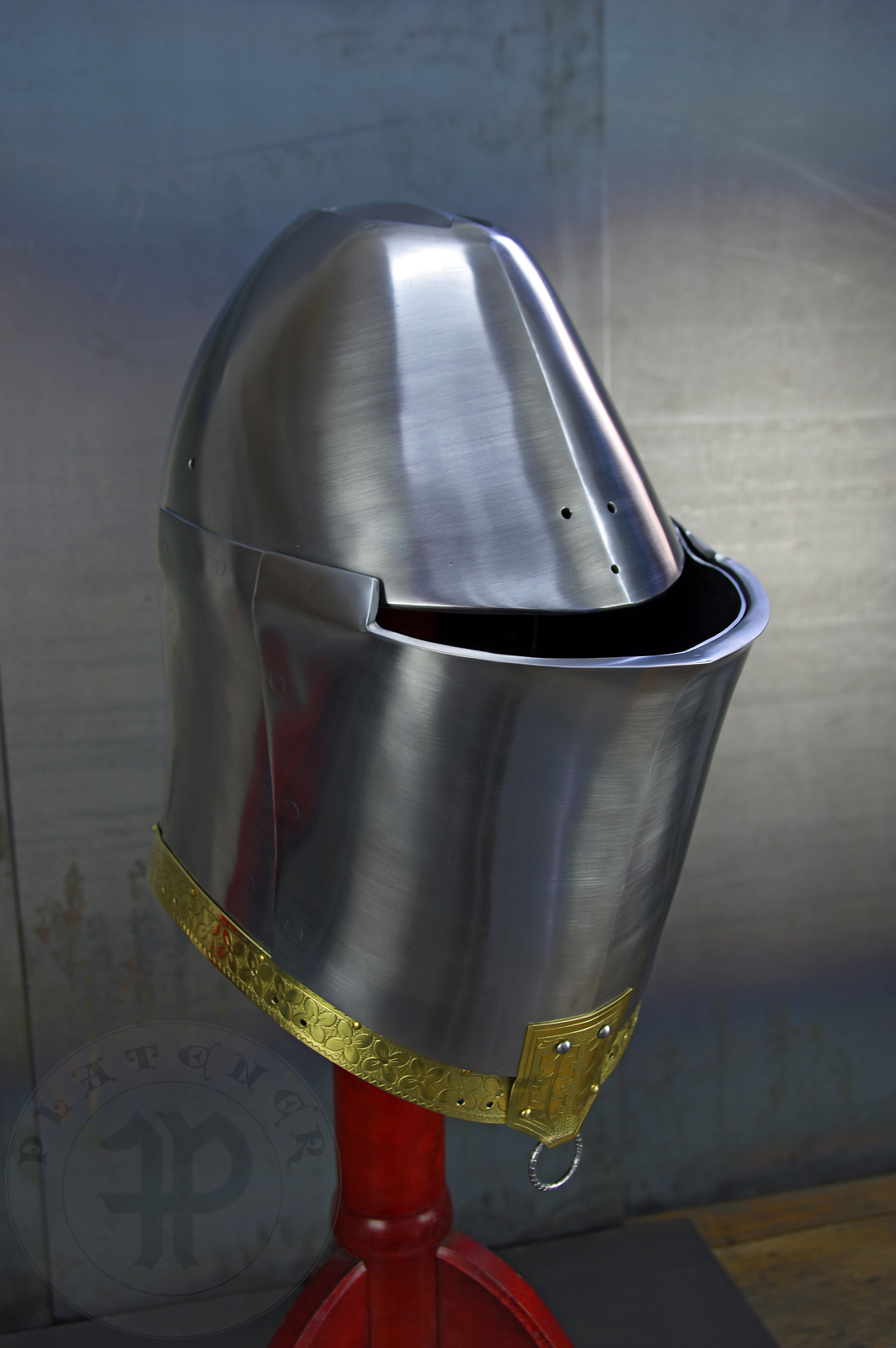 My interpretation of a tournament helm based on the Henry V helm - part of his funeral achievement from Westminster Abbey. It represents an early style of jousting helm dated for 1380-1420. It is composed of five primary plates: rear plate, brown plate, crown plate, face plate and monstrous thick reinforcing plate in front.