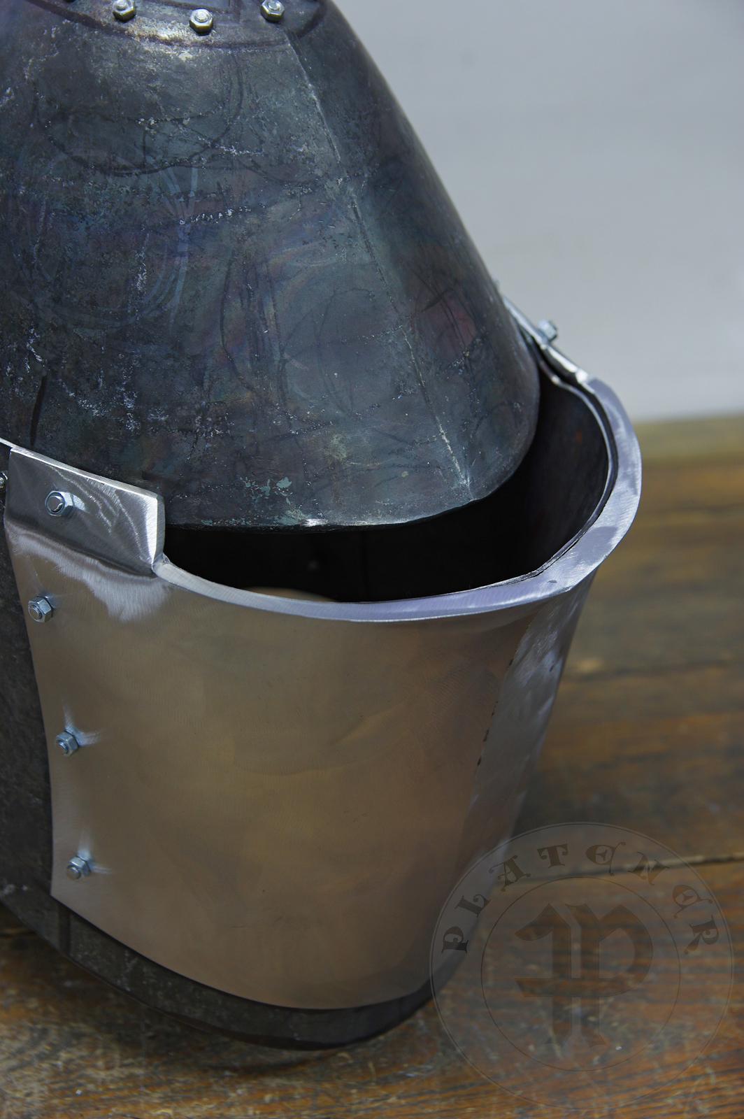 My interpretation of a tournament helm based on the Henry V helm - part of his funeral achievement from Westminster Abbey. It represents an early style of jousting helm dated for 1380-1420. It is composed of five primary plates: rear plate, brown plate, crown plate, face plate and monstrous thick reinforcing plate in front.