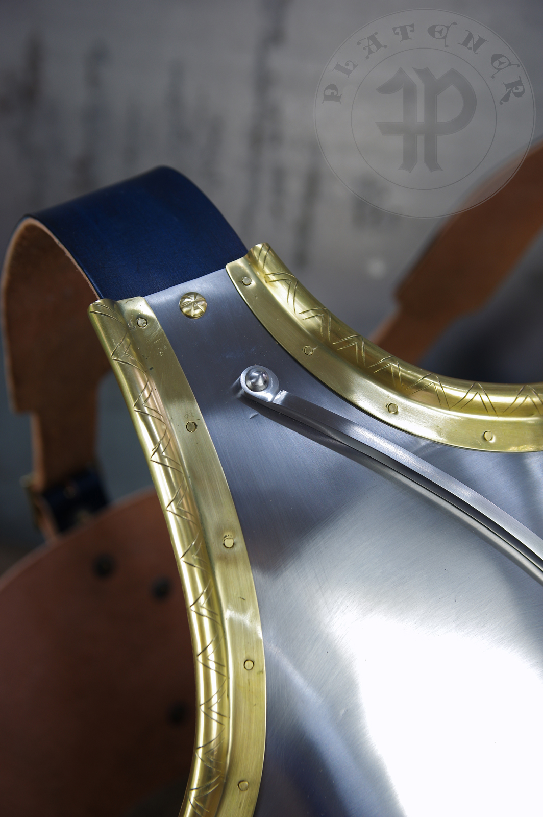 Here is a classic breastplate with V-neck stop rib (to deflect thrusts away from the neck) based on Churburg CH14. I enhanced its simple aesthetic by adding brass decorations around the edges with a geometrical, hand filed pattern. They were inspired by decorations from Churburg CH13 segmented breastplate and depictions in art from this period