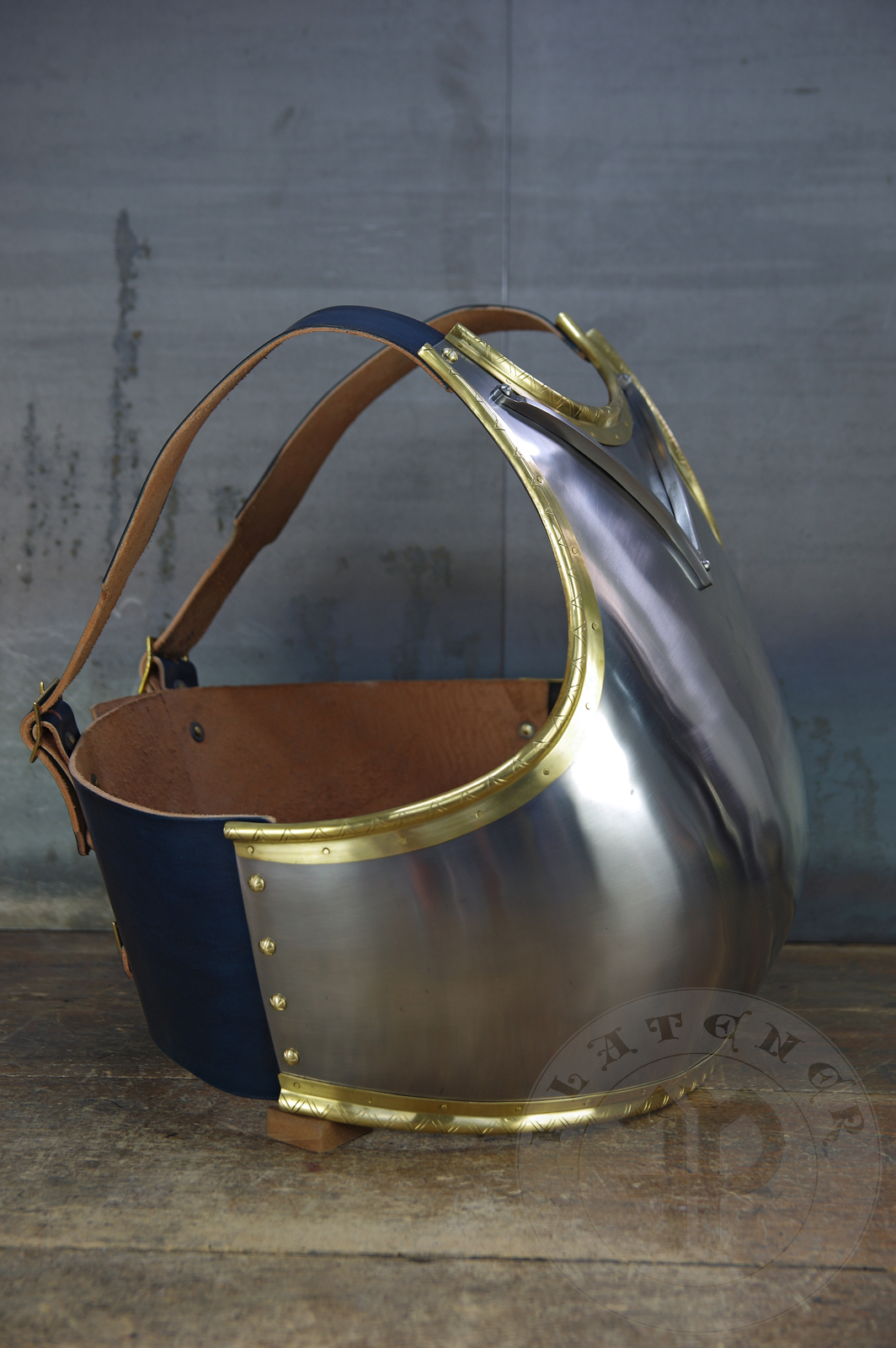 Here is a classic breastplate with V-neck stop rib (to deflect thrusts away from the neck) based on Churburg CH14. I enhanced its simple aesthetic by adding brass decorations around the edges with a geometrical, hand filed pattern. They were inspired by decorations from Churburg CH13 segmented breastplate and depictions in art from this period